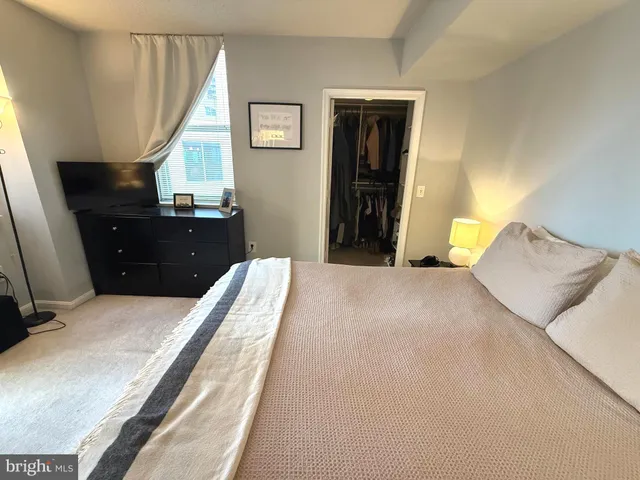 a bathroom with a granite countertop sink mirror vanity and toilet
