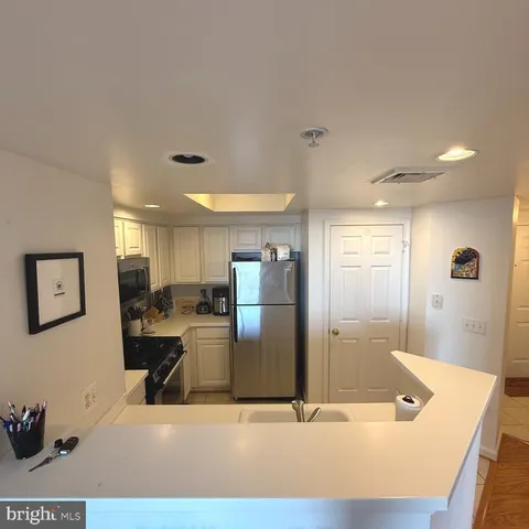 a kitchen with a sink a stove and refrigerator