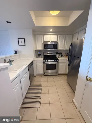 a living room with furniture a large window and wooden floor