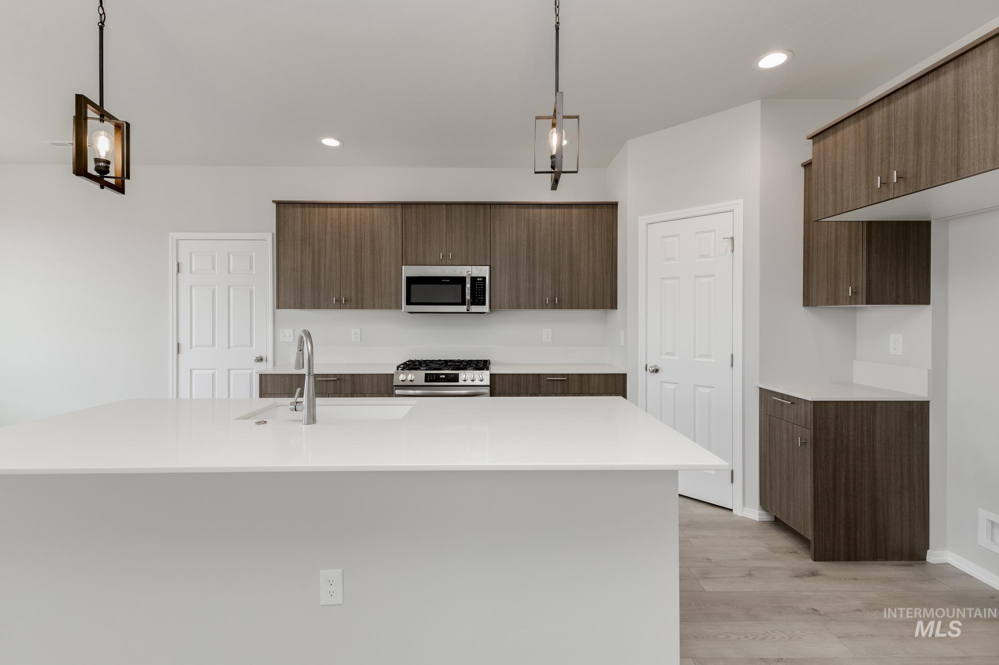12842 Ropers Street Nampa, ID 83651 - Photo 6 of 29 Kitchen island with integrated sink and chrome faucet
