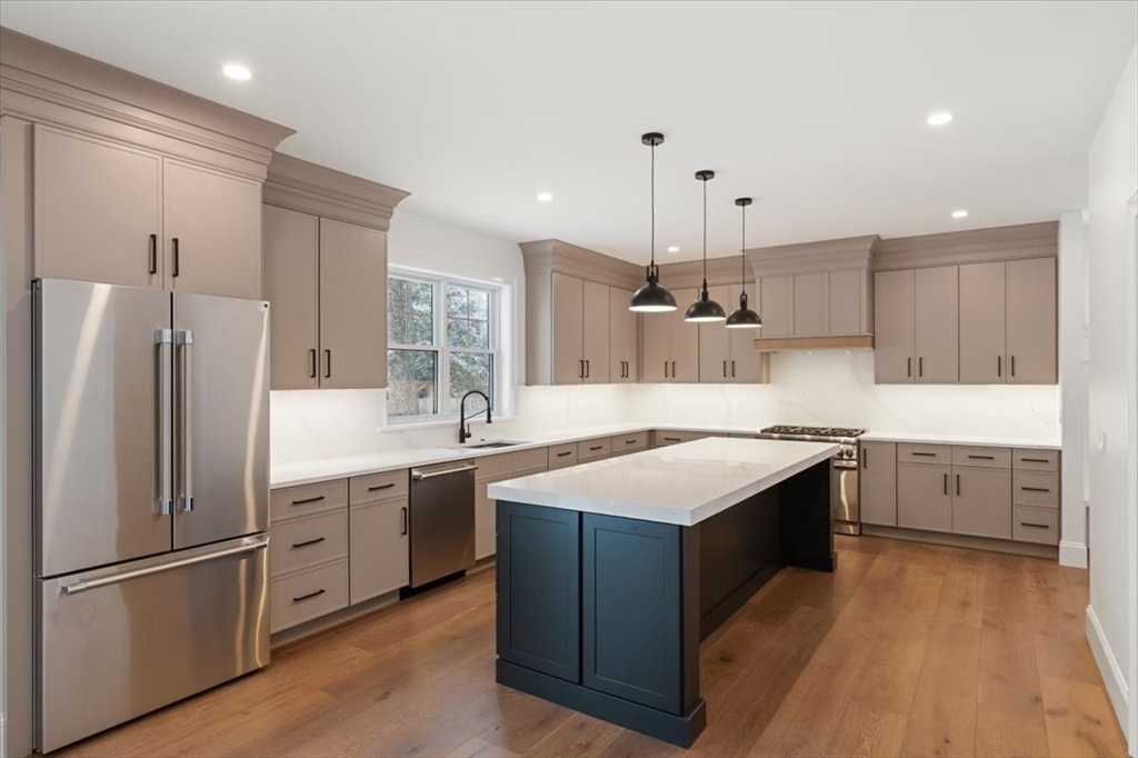 37 Longfellow Road Natick, MA 01760 - Photo 11 of 25 a kitchen with stainless steel appliances granite countertop a sink stove and refrigerator