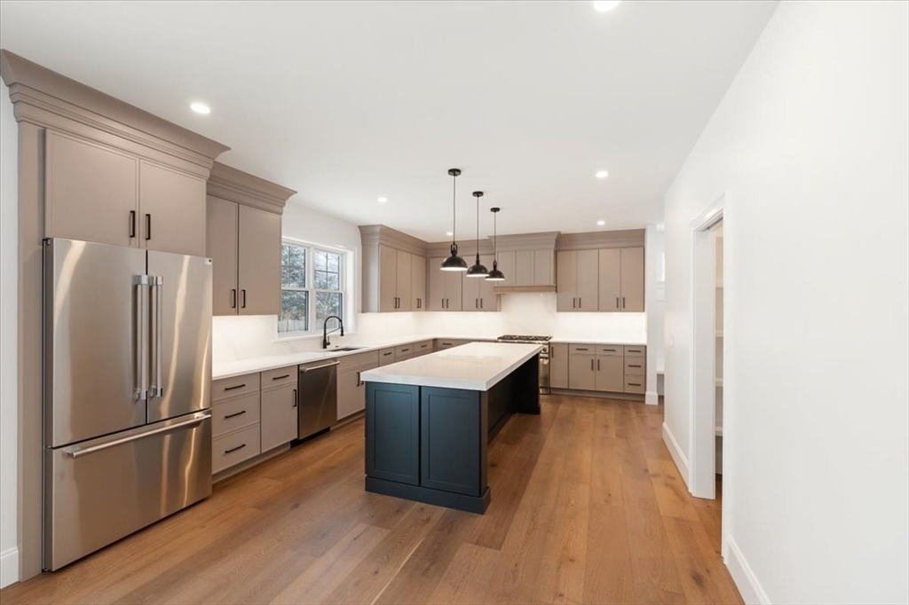 37 Longfellow Road Natick, MA 01760 - Photo 12 of 25 a kitchen with a sink a refrigerator a stove top oven and cabinets