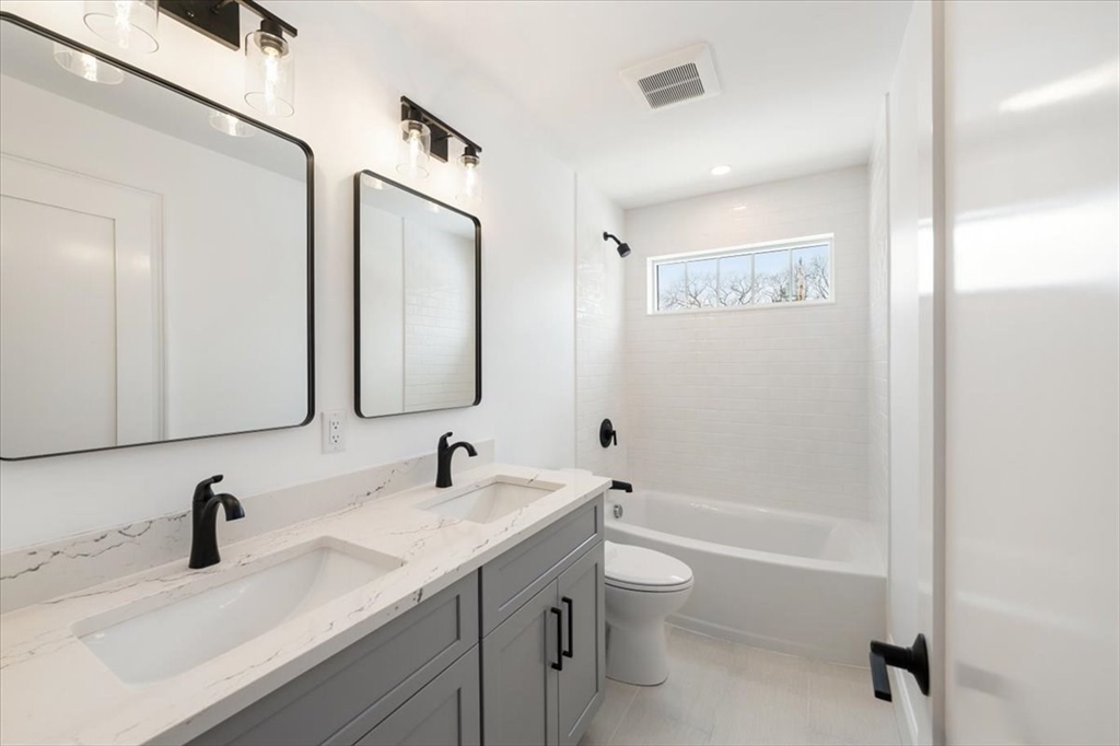 37 Longfellow Road Natick, MA 01760 - Photo 14 of 25 a bathroom with a granite countertop sink a toilet and a bathtub