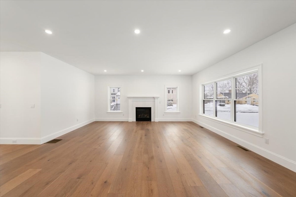 37 Longfellow Road Natick, MA 01760 - Photo 9 of 25 an empty room with wooden floor fireplace and windows