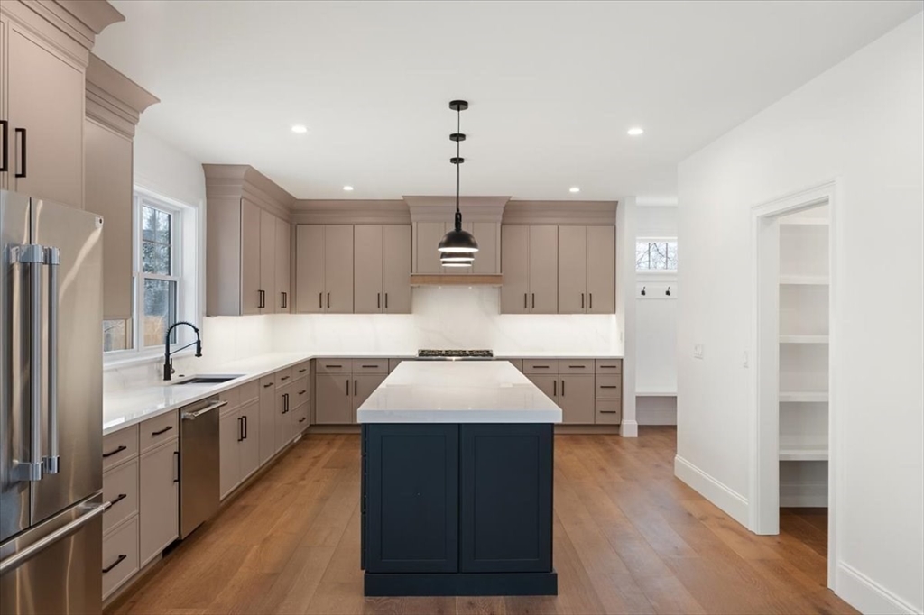 37 Longfellow Road Natick, MA 01760 - Photo 10 of 25 a kitchen with kitchen island granite countertop a sink and wooden floors