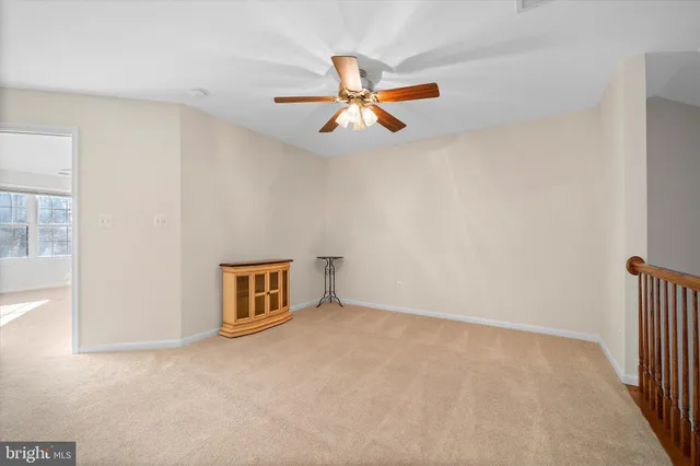 a view of empty room with ceiling fan