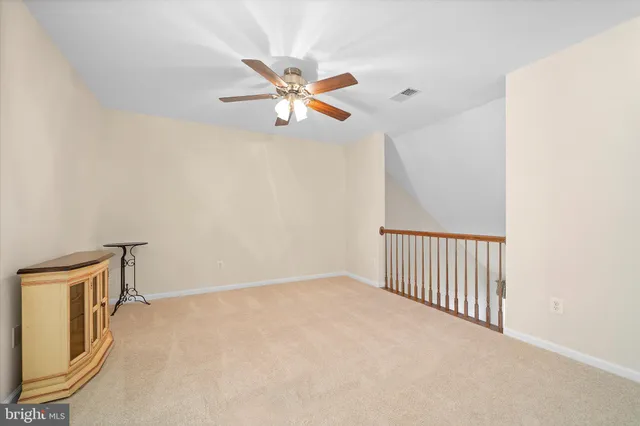 a living room with a bed furniture and a window