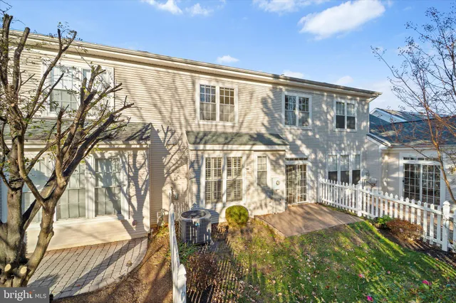 a view of a brick house with a small yard