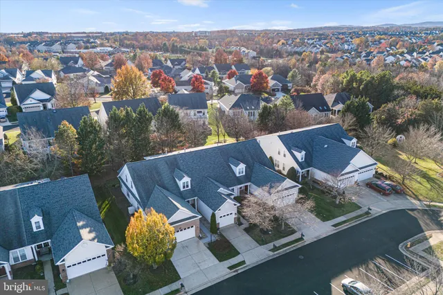 an aerial view of a house with garden space and swimming pool