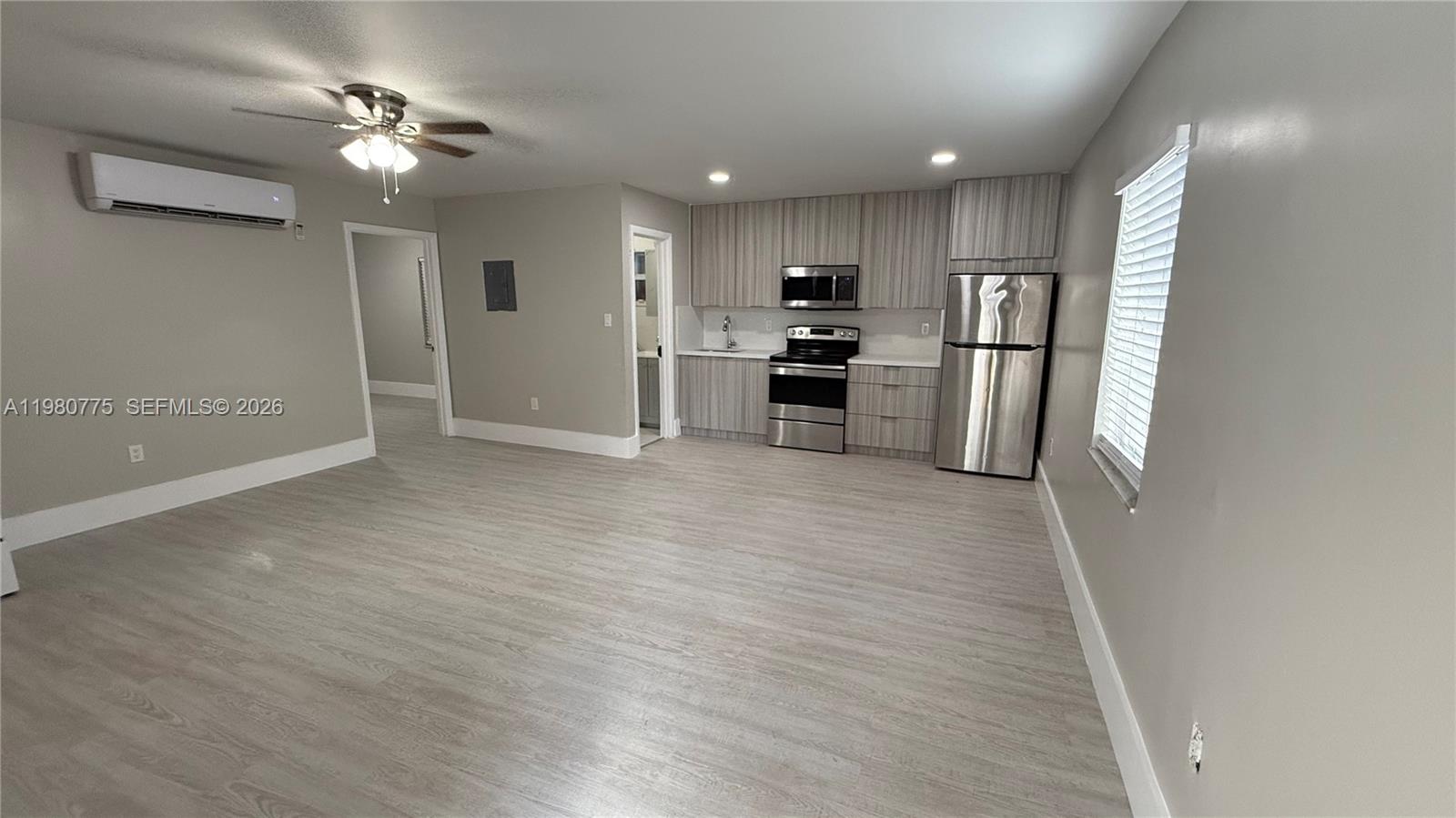 220 Northwest 12th Street Pompano Beach, FL 33060 - Photo 15 of 77 a view of kitchen with wooden floor electronic appliances and window