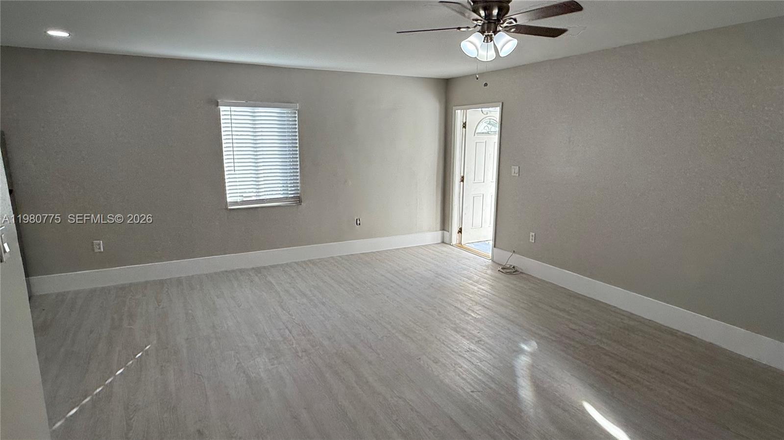 220 Northwest 12th Street Pompano Beach, FL 33060 - Photo 21 of 77 wooden floor in an empty room with a window