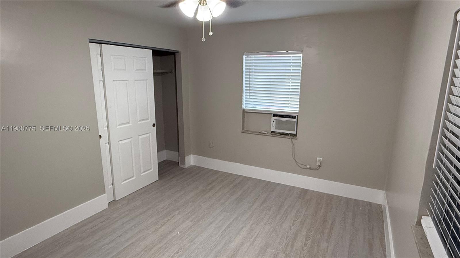 220 Northwest 12th Street Pompano Beach, FL 33060 - Photo 23 of 77 an empty room with wooden floor and windows