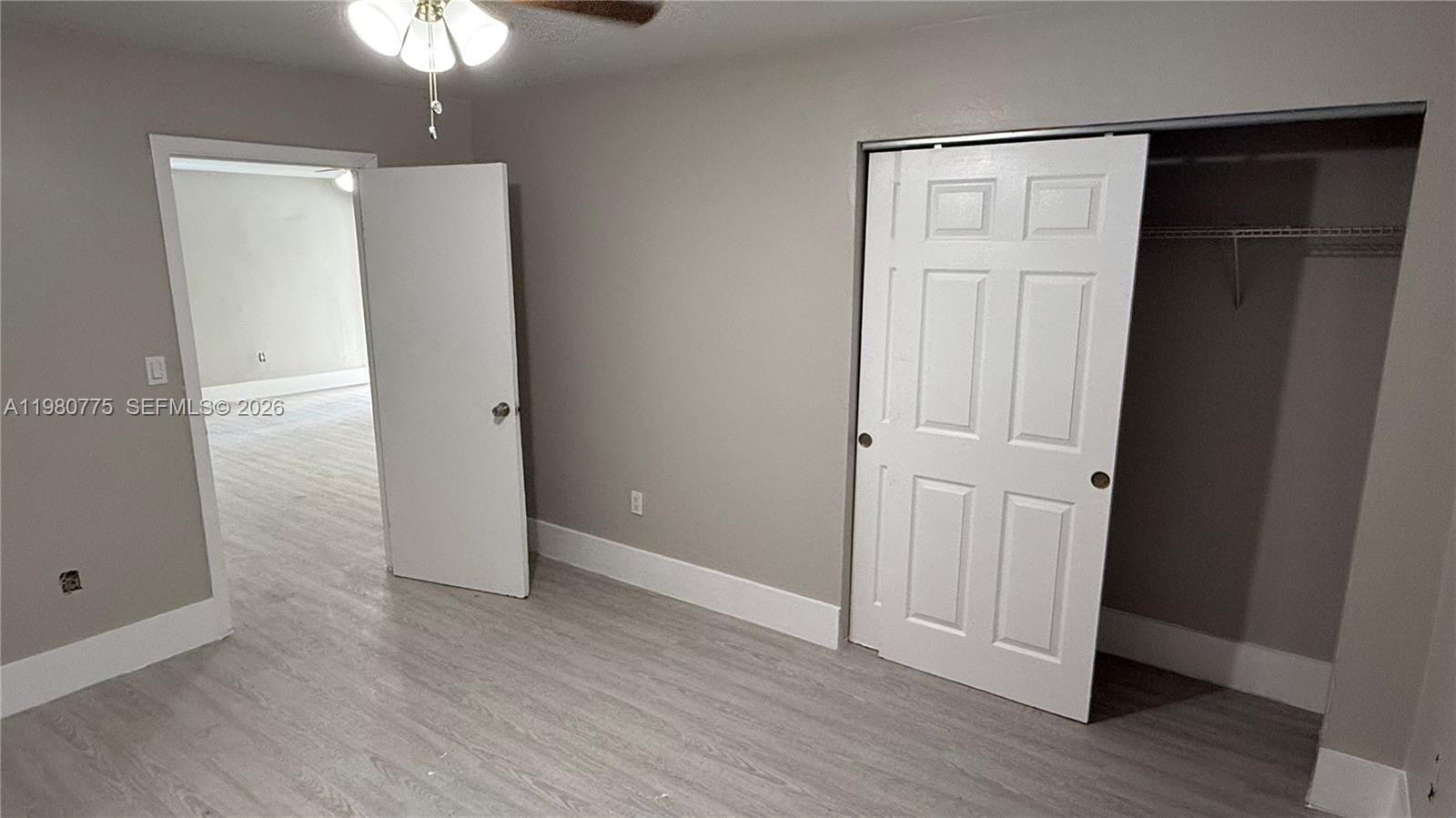 220 Northwest 12th Street Pompano Beach, FL 33060 - Photo 24 of 77 an empty room with wooden floor and closet area