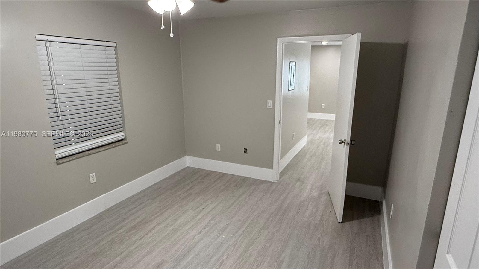 220 Northwest 12th Street Pompano Beach, FL 33060 - Photo 25 of 77 a view of a room with wooden floor and a window