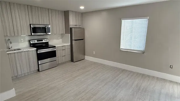 a view of a livingroom with a hardwood floor and a ceiling fan