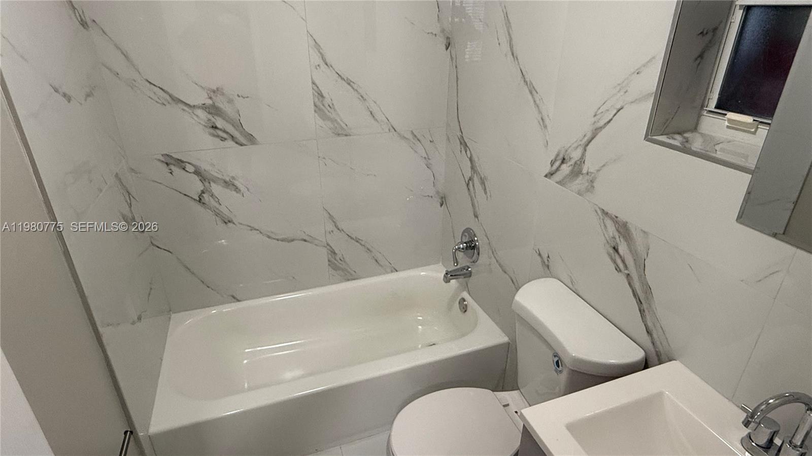 220 Northwest 12th Street Pompano Beach, FL 33060 - Photo 29 of 77 a bathroom with a toilet and a bathtub