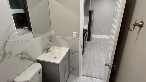 a kitchen with stainless steel appliances granite countertop a stove a refrigerator and a microwave