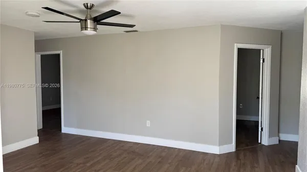 a view of a hallway with wooden floor