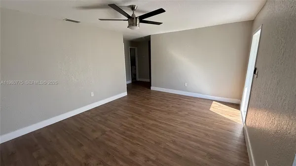 wooden floor in an empty room and a window