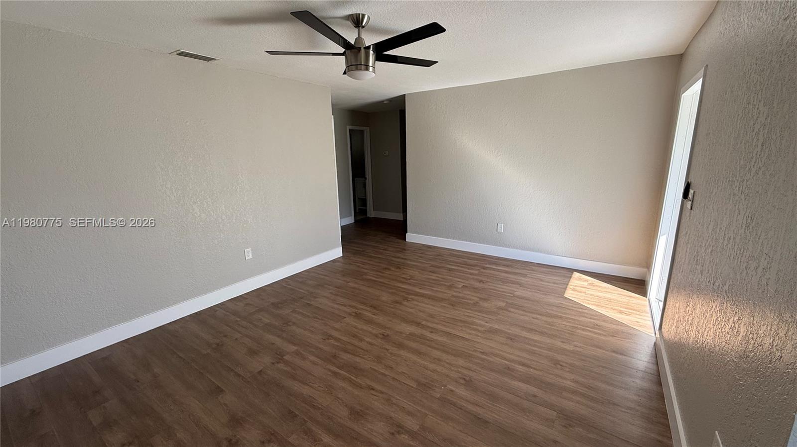 220 Northwest 12th Street Pompano Beach, FL 33060 - Photo 33 of 77 a view of an empty room with wooden floor