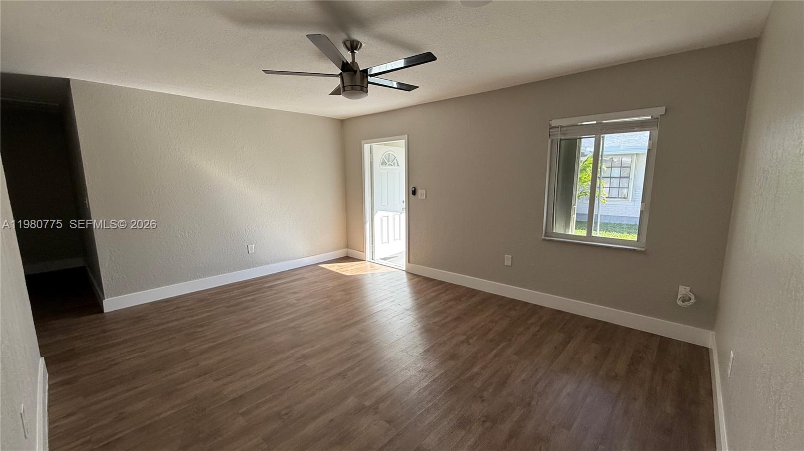 220 Northwest 12th Street Pompano Beach, FL 33060 - Photo 34 of 77 a view of a livingroom with a hardwood floor and a ceiling fan