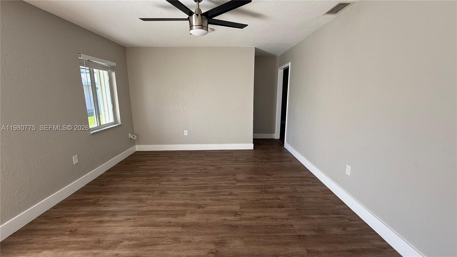 220 Northwest 12th Street Pompano Beach, FL 33060 - Photo 36 of 77 wooden floor in an empty room with a window