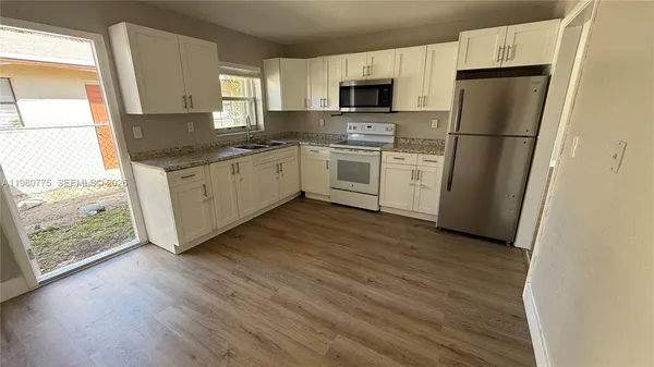 a bathroom with a sink a toilet and bathtub