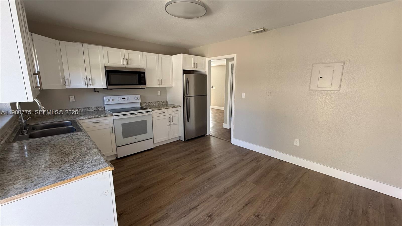 220 Northwest 12th Street Pompano Beach, FL 33060 - Photo 39 of 77 a kitchen with stainless steel appliances granite countertop a stove a refrigerator and a microwave