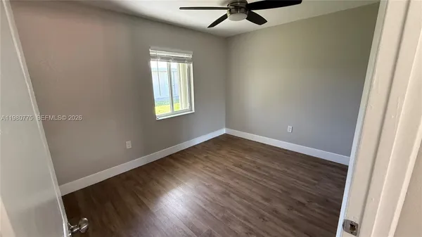 a view of an empty room and a window