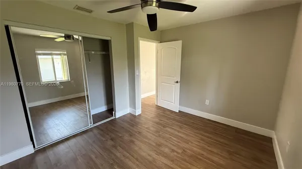 a bathroom with a glass door and a hallway