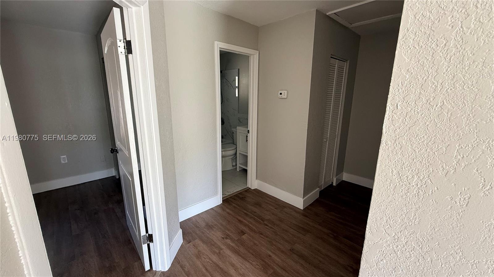 220 Northwest 12th Street Pompano Beach, FL 33060 - Photo 45 of 77 an empty room with wooden floor and entrance
