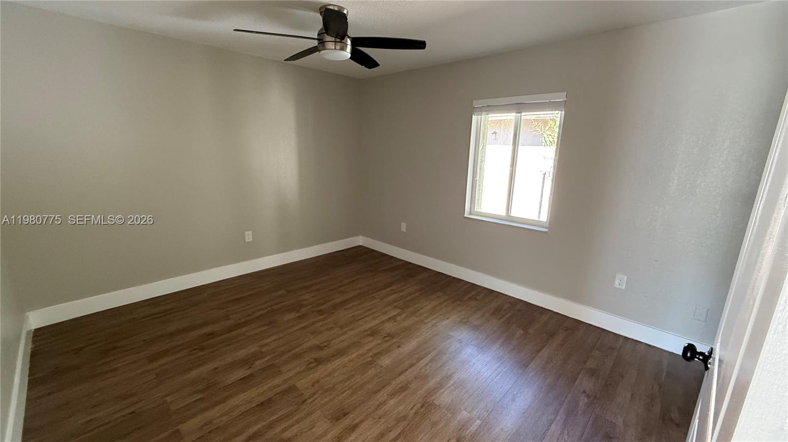 220 Northwest 12th Street Pompano Beach, FL 33060 - Photo 46 of 77 wooden floor in an empty room with a window