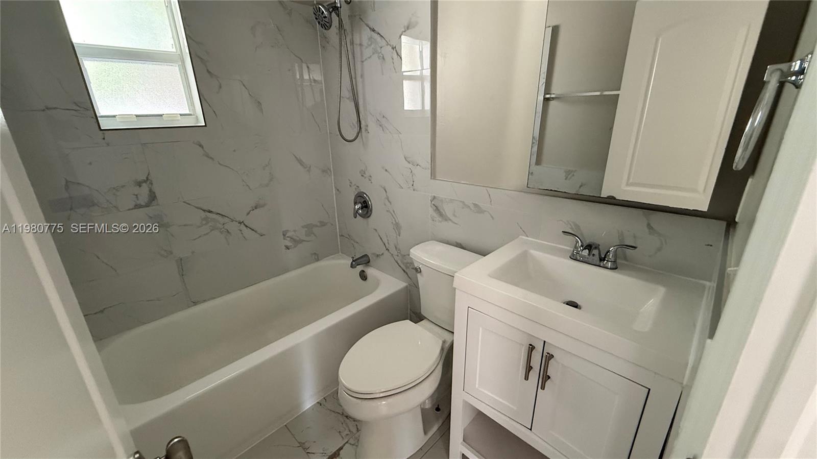 220 Northwest 12th Street Pompano Beach, FL 33060 - Photo 52 of 77 a bathroom with a sink a toilet and bathtub