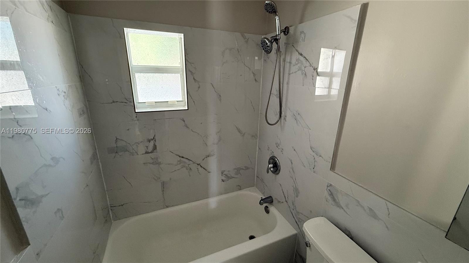 220 Northwest 12th Street Pompano Beach, FL 33060 - Photo 54 of 77 a bathroom with a bathtub and a shower