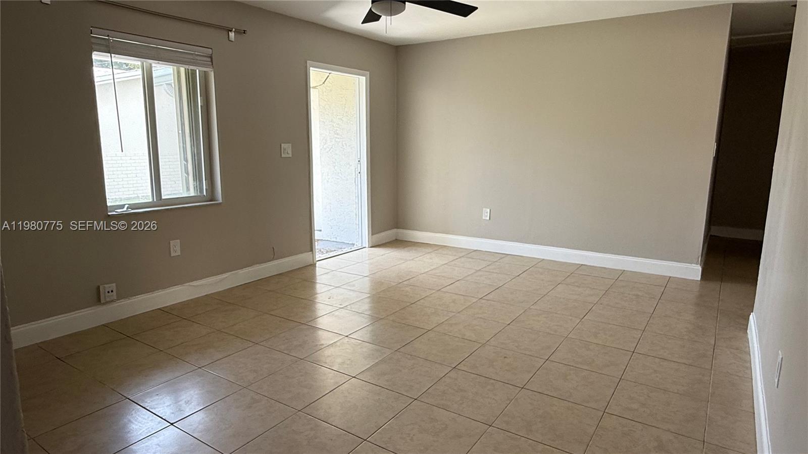 220 Northwest 12th Street Pompano Beach, FL 33060 - Photo 58 of 77 an empty room with windows and chandelier fan