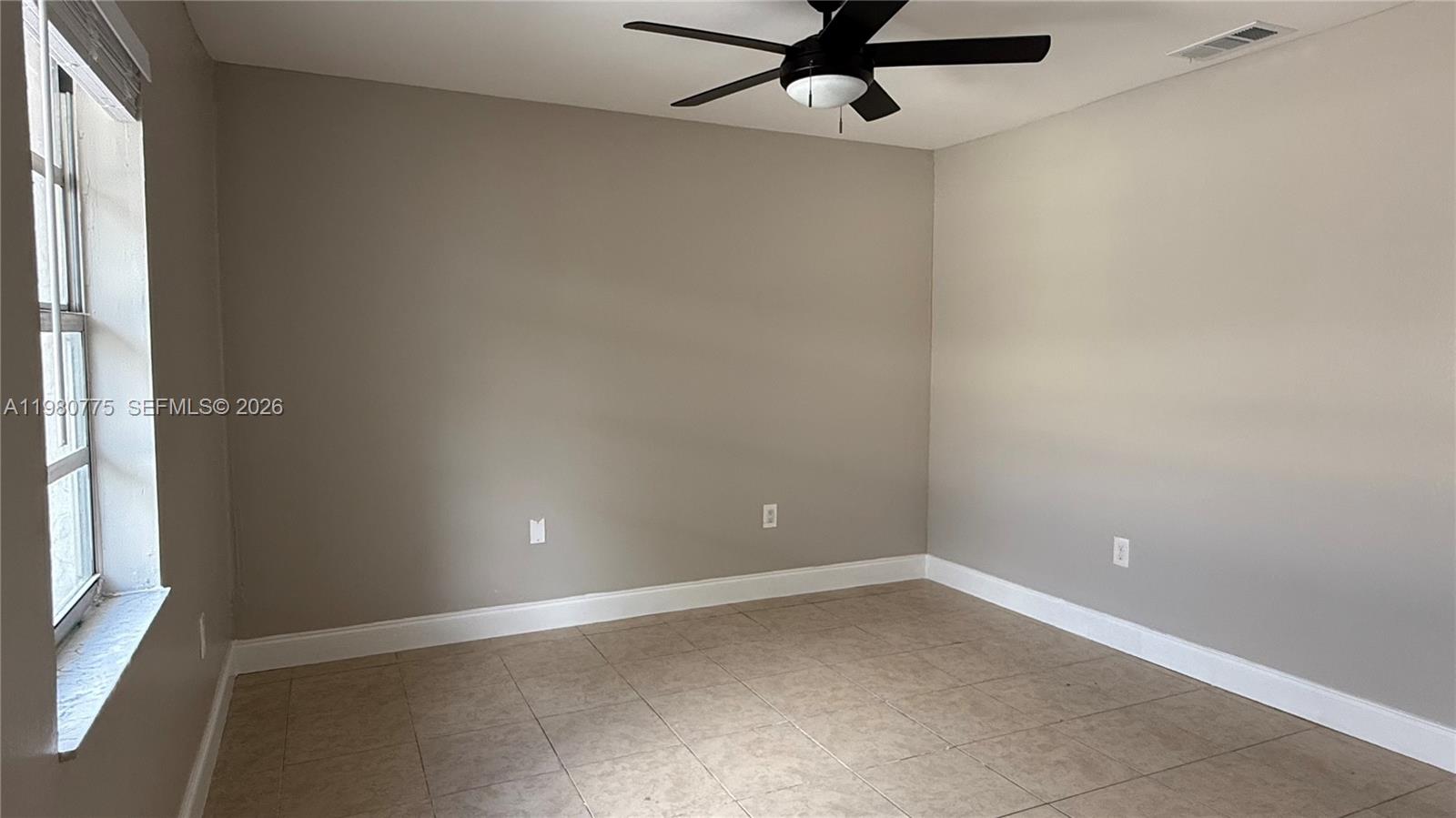220 Northwest 12th Street Pompano Beach, FL 33060 - Photo 63 of 77 an empty room with a window and a fan