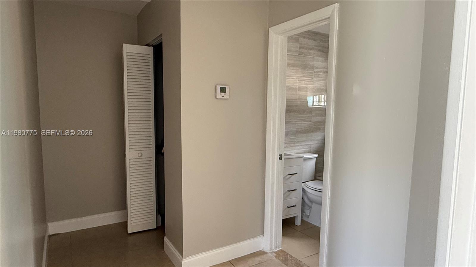 220 Northwest 12th Street Pompano Beach, FL 33060 - Photo 64 of 77 a bathroom with a glass door and a hallway