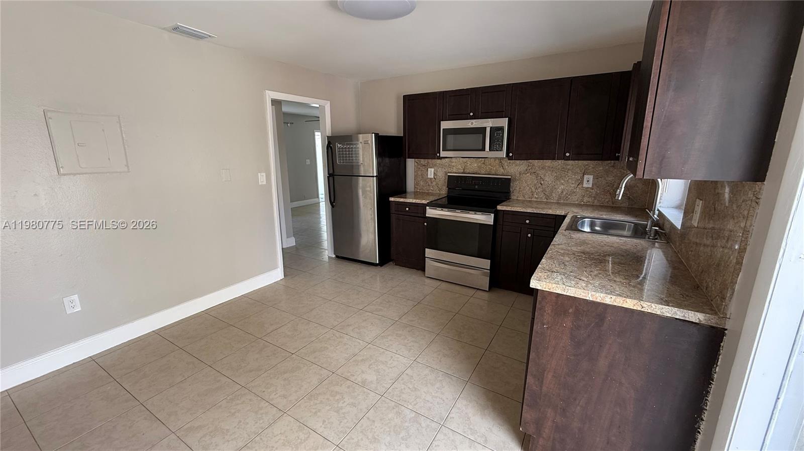 220 Northwest 12th Street Pompano Beach, FL 33060 - Photo 75 of 77 a kitchen with a refrigerator stove and microwave