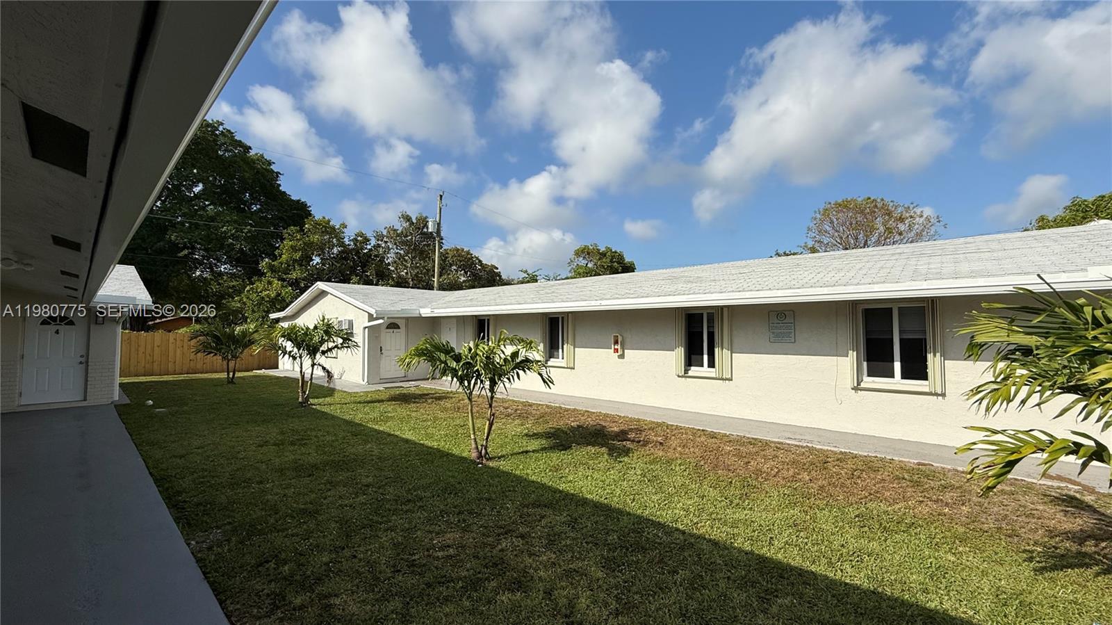 220 Northwest 12th Street Pompano Beach, FL 33060 - Photo 10 of 77 a front view of a house with a yard