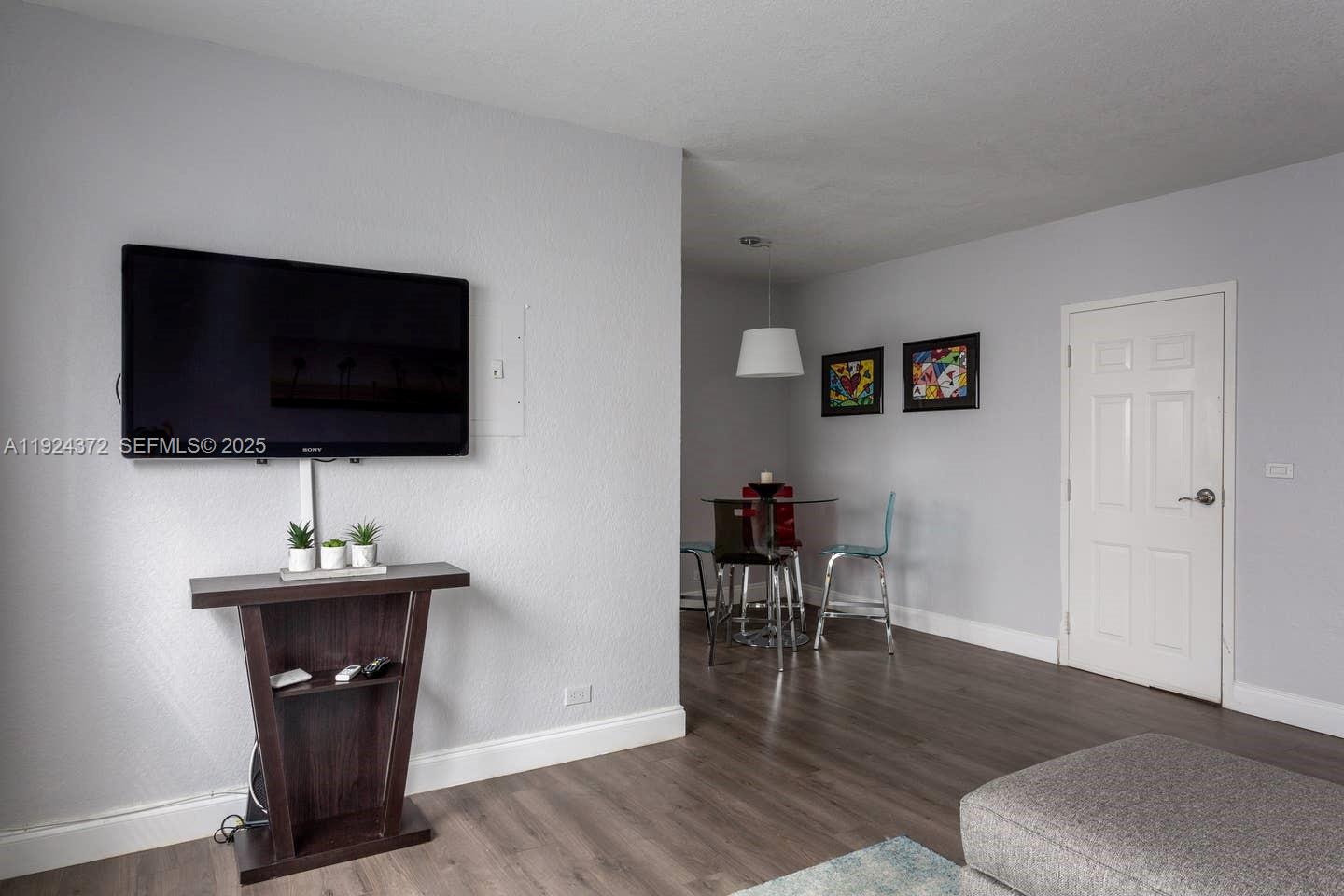 7334 Harding Avenue, Unit 6 Miami Beach, FL 33141 - Photo 3 of 12 a living room with furniture and a flat screen tv