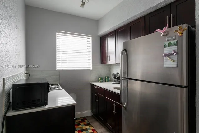 a kitchen with a refrigerator and a sink