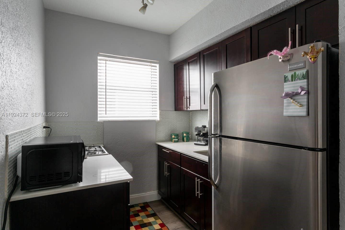 7334 Harding Avenue, Unit 6 Miami Beach, FL 33141 - Photo 5 of 12 a kitchen with a refrigerator and a sink