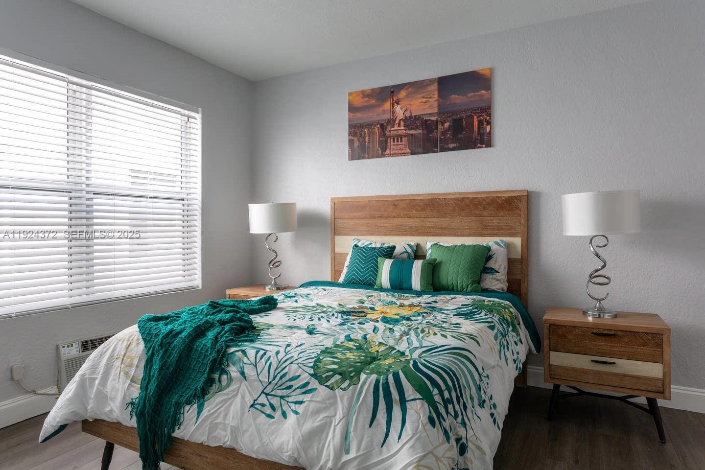 7334 Harding Avenue, Unit 6 Miami Beach, FL 33141 - Photo 6 of 12 a bedroom with a bed and a window