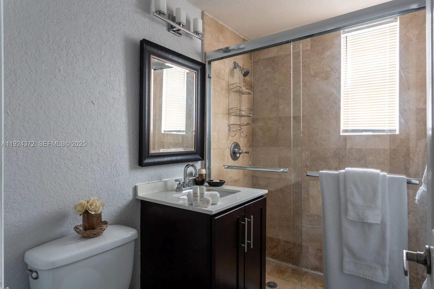 7334 Harding Avenue, Unit 6 Miami Beach, FL 33141 - Photo 7 of 12 a bathroom with a sink toilet and shower
