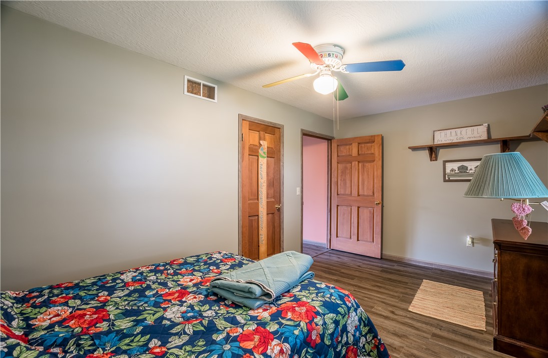 1319 Perry Road Cable, OH 43009 - Photo 22 of 44 This cozy bedroom features durable flooring and a ceiling fan for comfort.