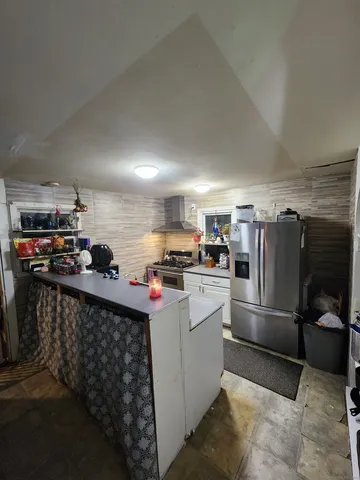 a kitchen with refrigerator and cabinets