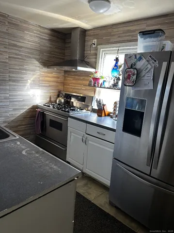 a kitchen with stainless steel appliances and white cabinets
