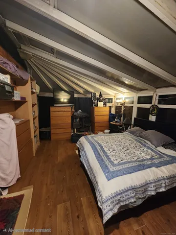 a bedroom with a bed next to a window