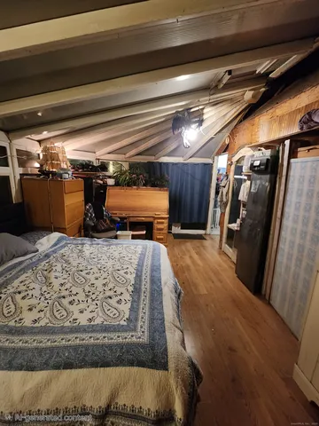 a large bed sitting in a bedroom next to a window