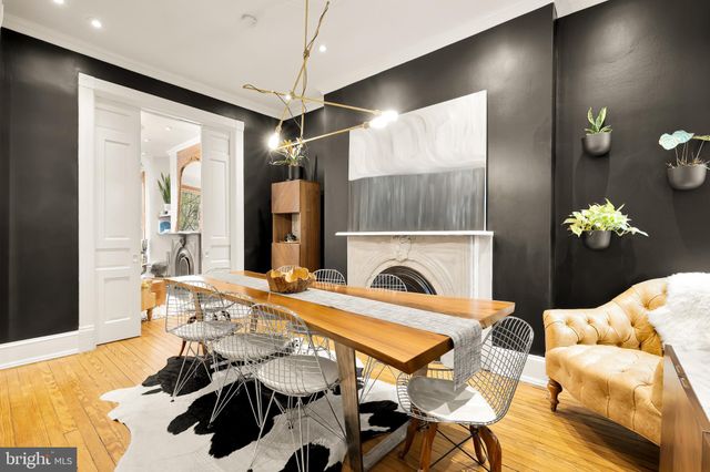 a very nice looking dining room with a fireplace and a chandelier